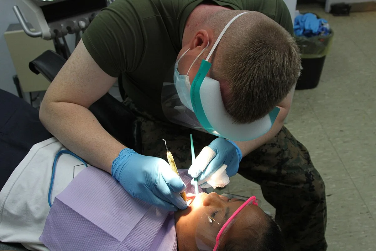 Military surgeon performing pediatric dentistry in the Northern Mariana Islands, 2012-12-03